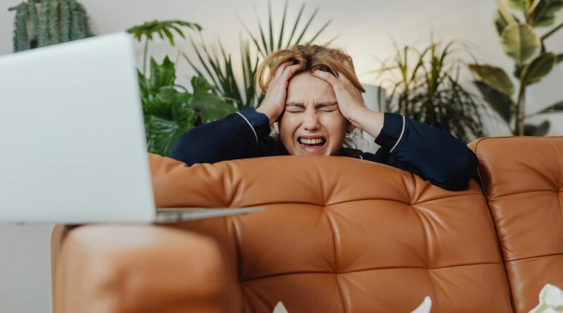 A person looking slightly frustrated while trying to set up smart home devices in a modern living room.