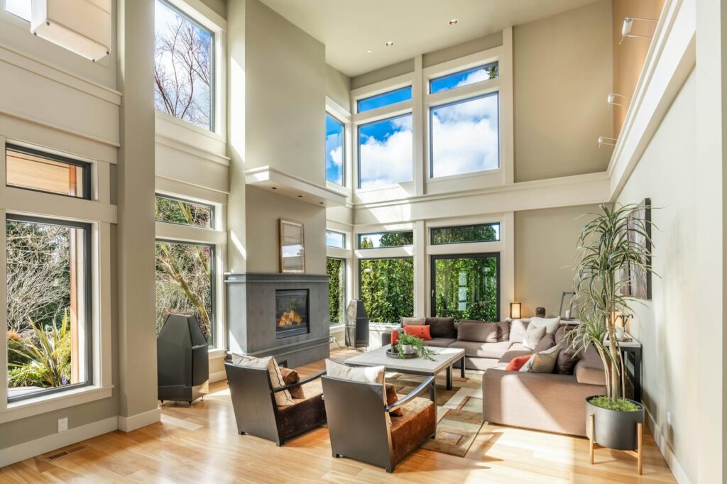 A beautifully lit modern living room with large windows and minimalist decor