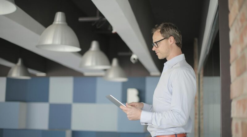 A sleek tablet mounted on a modern living room wall