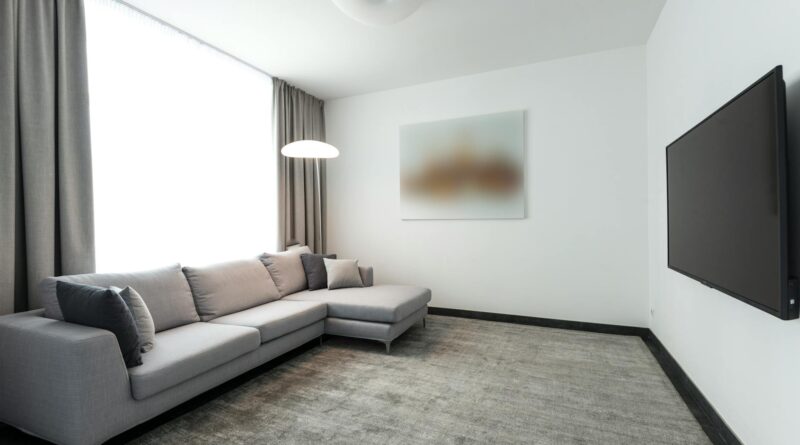 A clean, minimalist living room with hidden technology