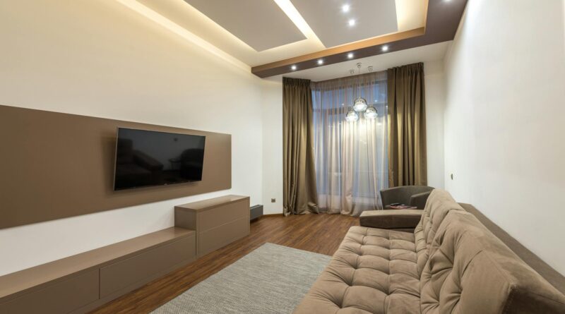 A modern living room with warm, layered ambient lighting