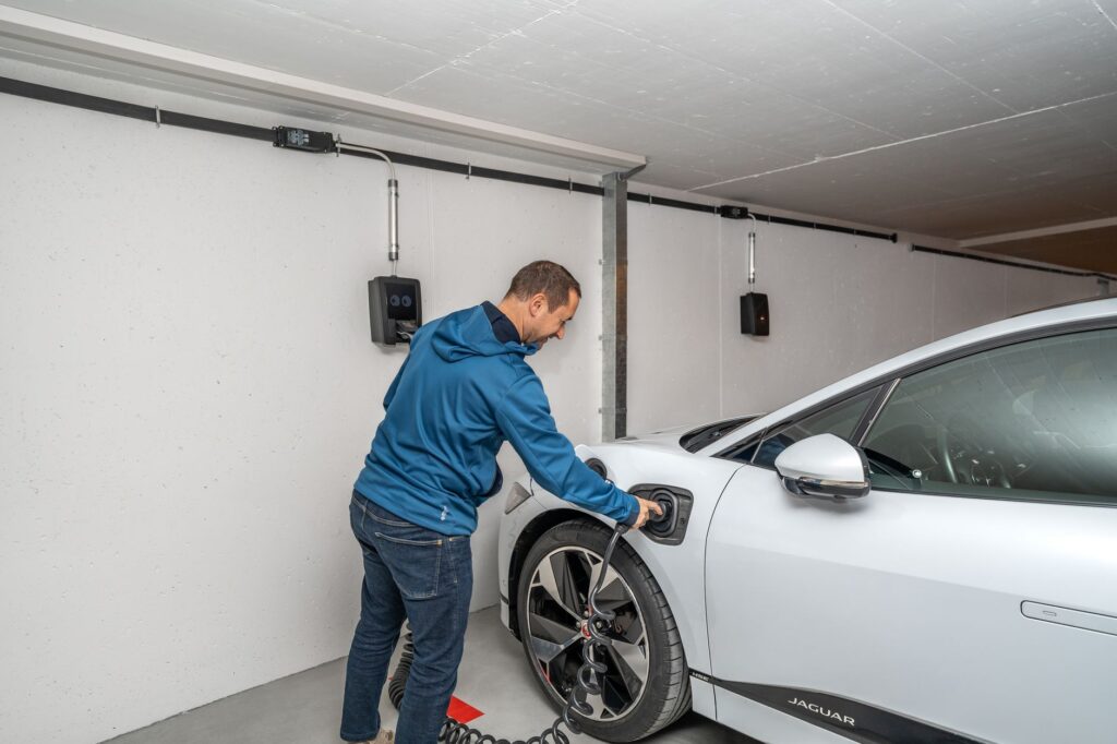 A modern home battery storage system mounted on a garage wall
